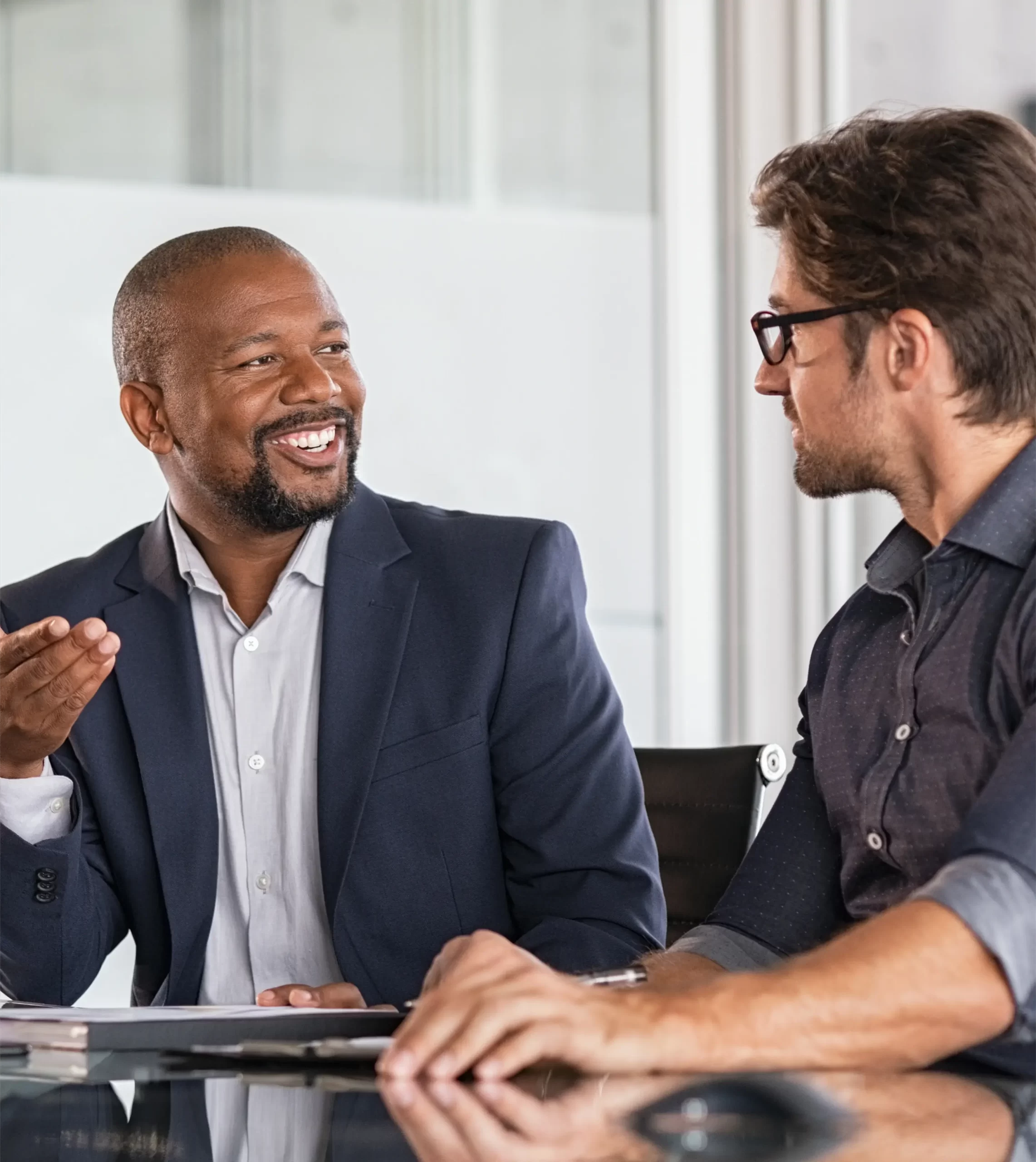 Modern brick office building with large windows and planters along the walkway