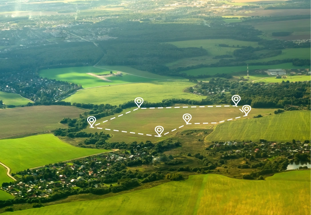 Aerial view of farmland with outlined plots marked for development